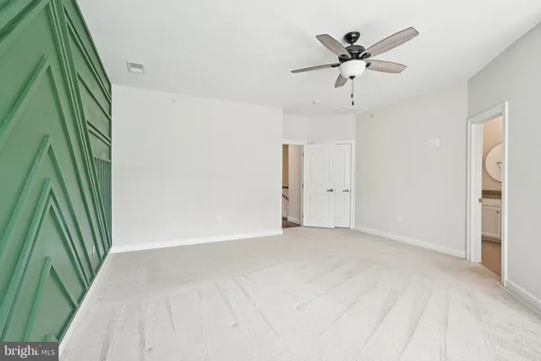 a view of an empty room with a ceiling fan