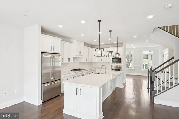 a kitchen with stainless steel appliances and white cabinets