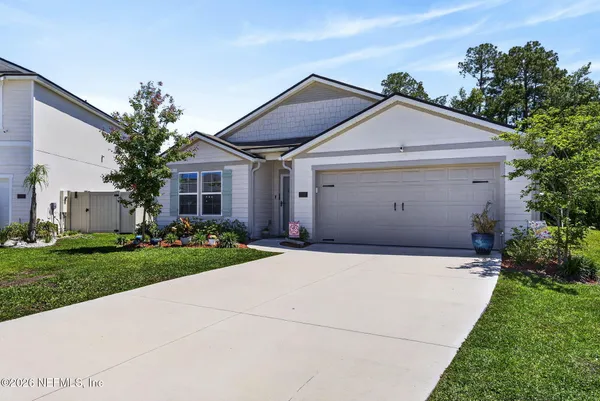 a front view of a house with a yard and garage