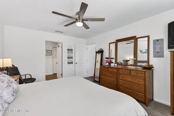 a bedroom with a bed and a large mirror