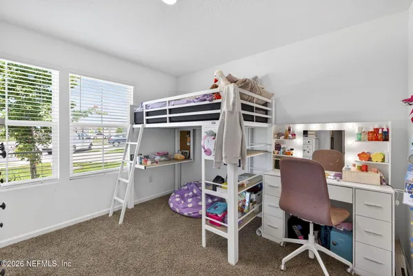 a bedroom with furniture and a window