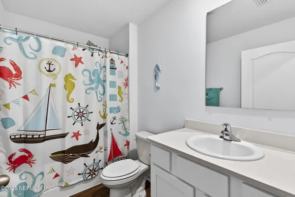 a bathroom with a sink and a white toilet
