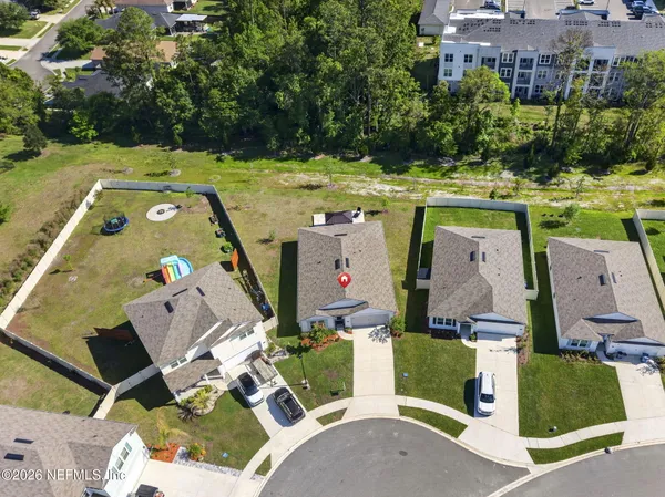 an aerial view of multiple houses with yard
