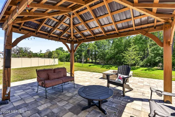 a backyard of a house with garden and outdoor seating