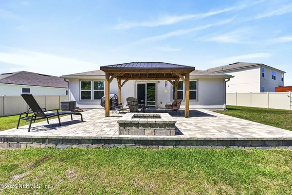 a view of a house with backyard porch and sitting area