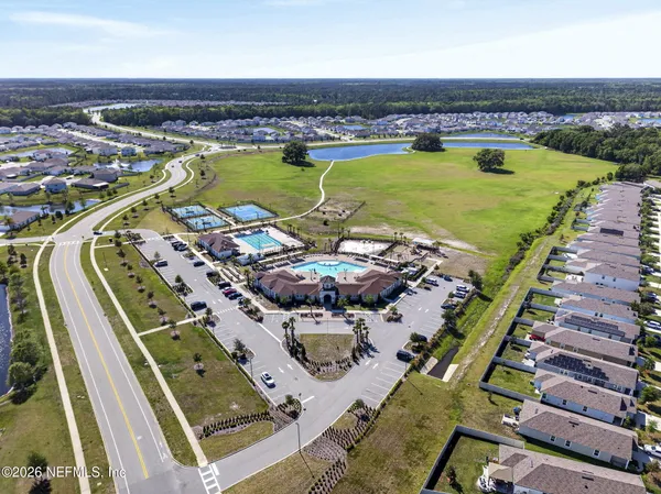 aerial view of a swimming pool with outdoor seating and yard