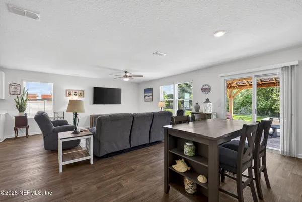 a view of a dining room with furniture and wooden floor