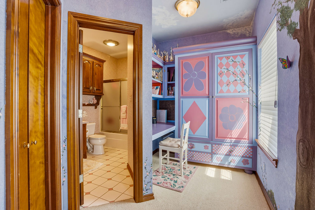 1009 Southeast County Road Ada, OK 74820 - Photo 39 of 92 Wood-finish bi-fold doors, wood-finish door frames, ceiling-mounted light fixture, patterned wallpaper, and tile flooring in the bathroom