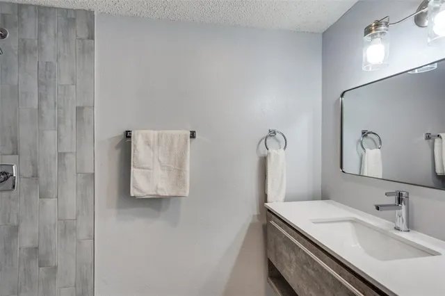 a bathroom with a sink and mirror
