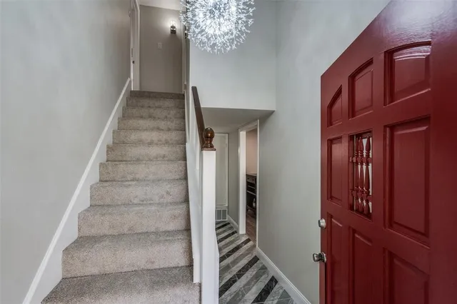 a view of entryway and hall with a chandelier