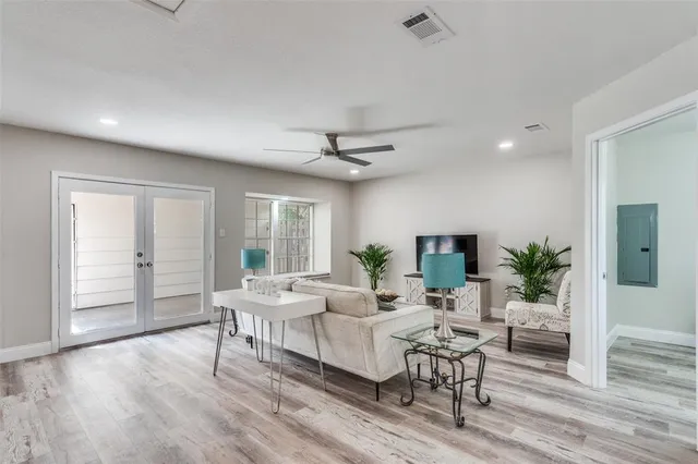 a living room with furniture and a wooden floor