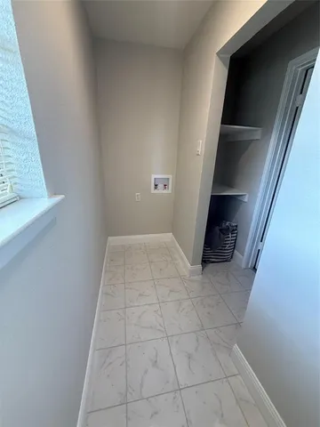 a view of an empty room and staircase