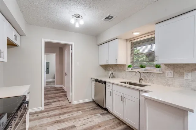 a kitchen with a sink cabinets and window