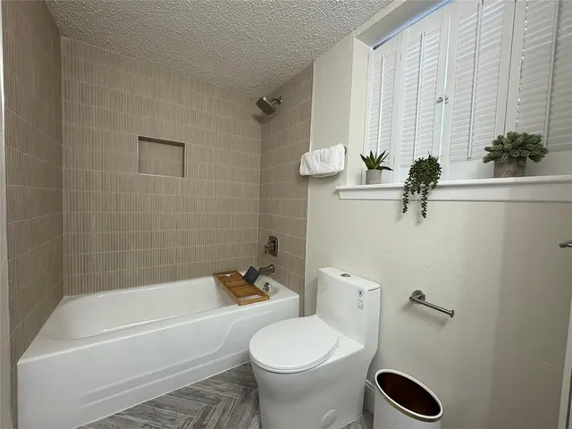 a bathroom with a sink a toilet and bathtub