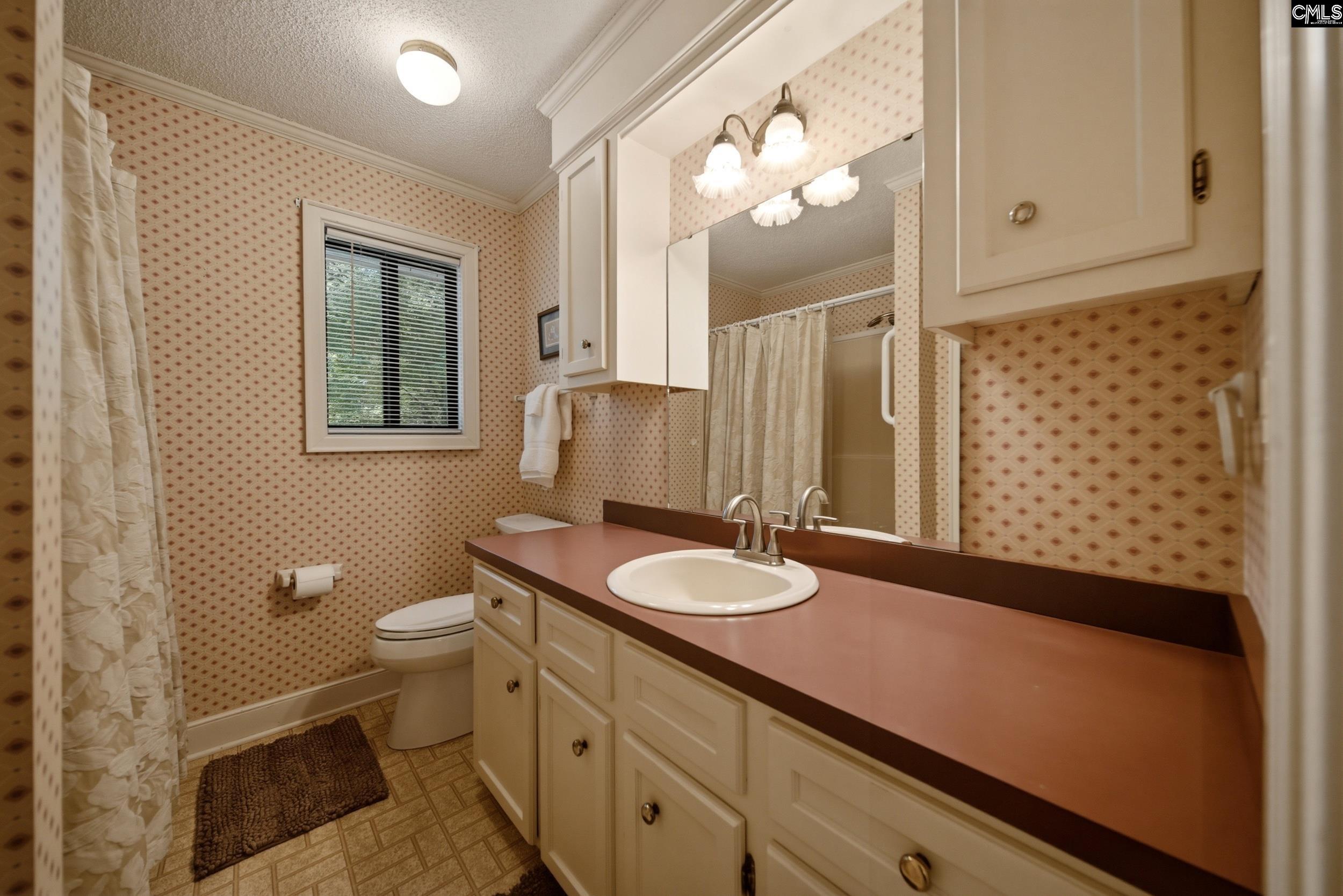 4324 Syrup Mill Road Ridgeway, SC 29130 - Photo 33 of 61 a bathroom with a granite countertop sink toilet and mirror