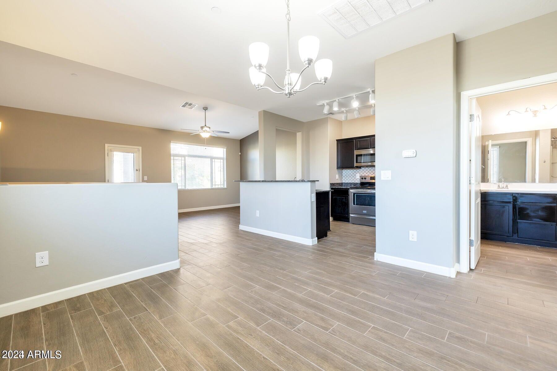 2150 West Alameda Road, Unit 1169 Phoenix, AZ 85085 - Photo 20 of 26 a view of a kitchen with a sink and a refrigerator