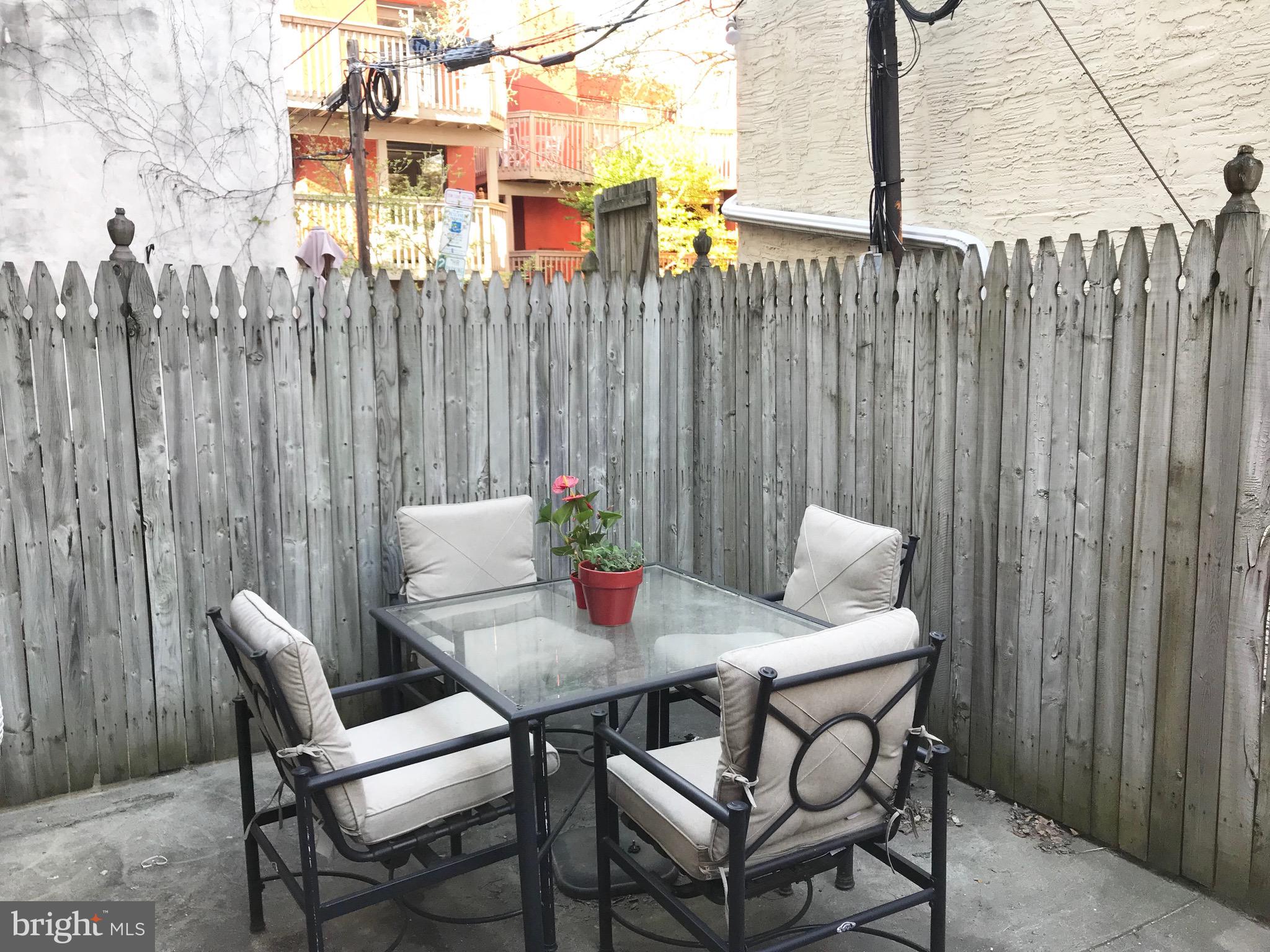 511 South 17th Street, Unit 1 Philadelphia, PA 19146 - Photo 12 of 15 a table and chairs in front of a house
