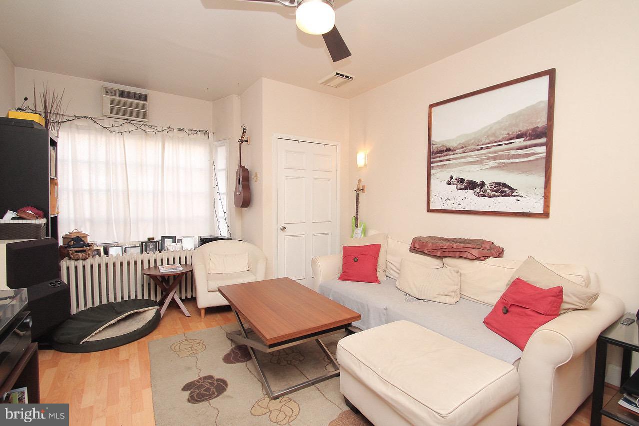 511 South 17th Street, Unit 1 Philadelphia, PA 19146 - Photo 6 of 15 a living room with furniture a flat screen tv and a window
