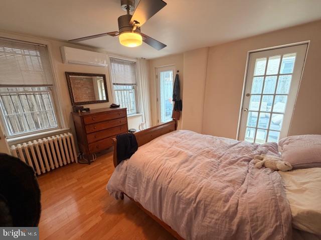511 South 17th Street, Unit 1 Philadelphia, PA 19146 - Photo 8 of 15 a bedroom with a bed and a chandelier