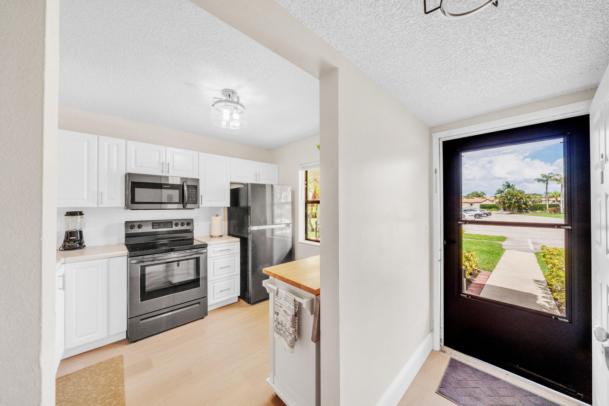 22136 Palms Way, Unit 103 Boca Raton, FL 33433 - Photo 35 of 42 a kitchen with stainless steel appliances granite countertop a refrigerator and a stove top oven