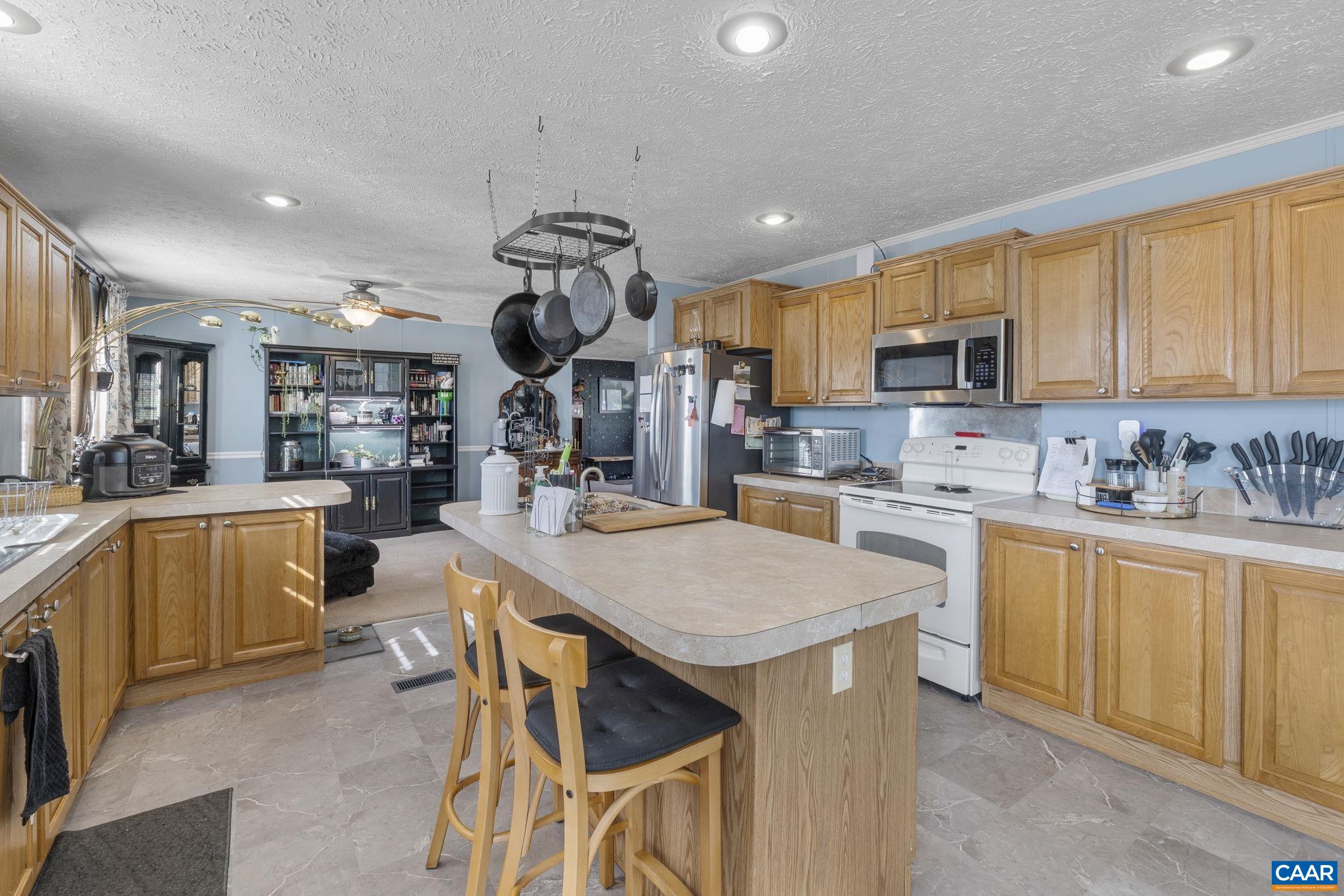 1173 Aylor Road Madison, VA 22727 - Photo 12 of 44 a kitchen with stainless steel appliances granite countertop a sink a stove a refrigerator cabinets and a dining table