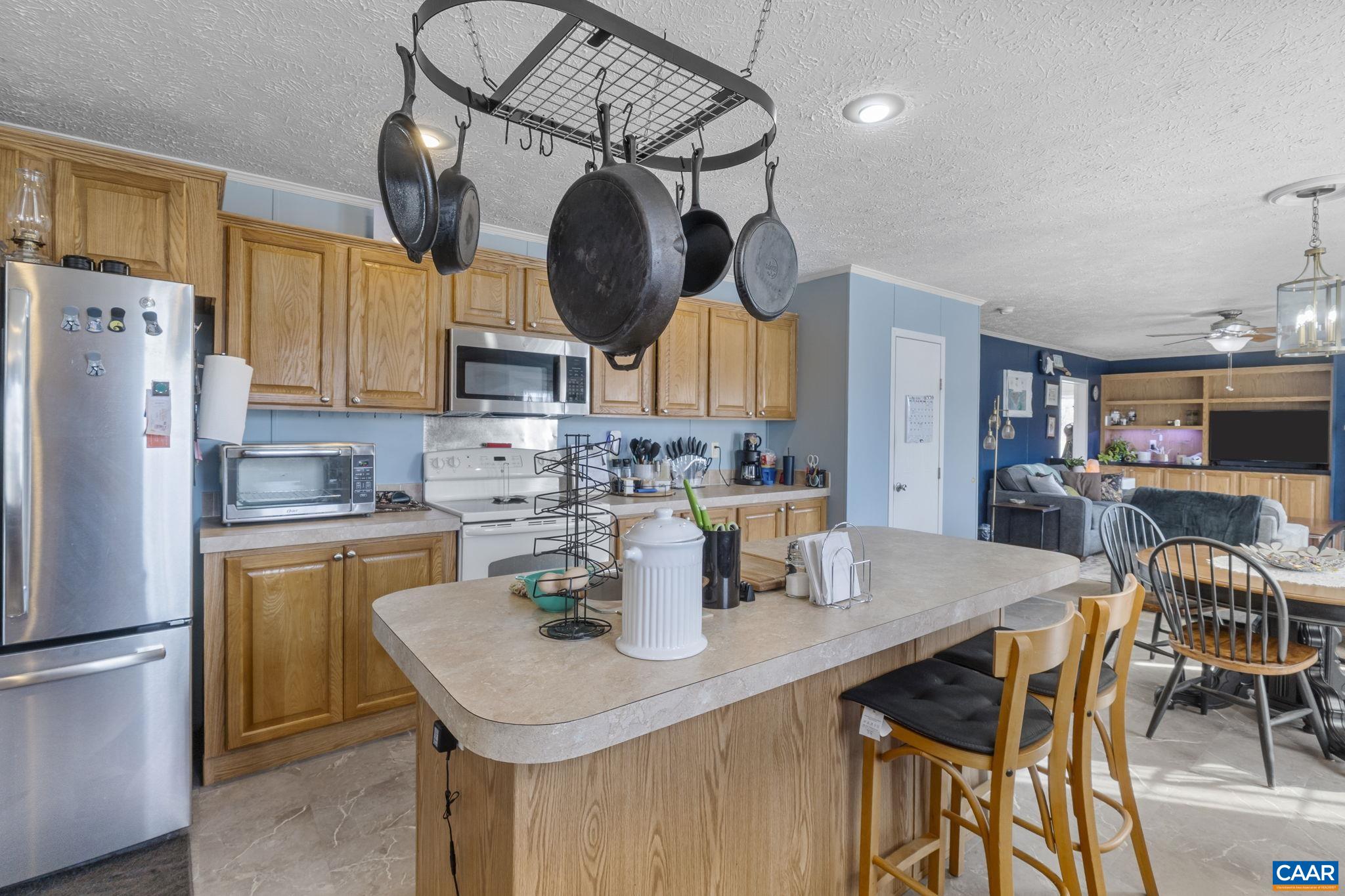 1173 Aylor Road Madison, VA 22727 - Photo 13 of 44 a kitchen with stainless steel appliances granite countertop a sink a stove a refrigerator cabinets a dining table and chairs