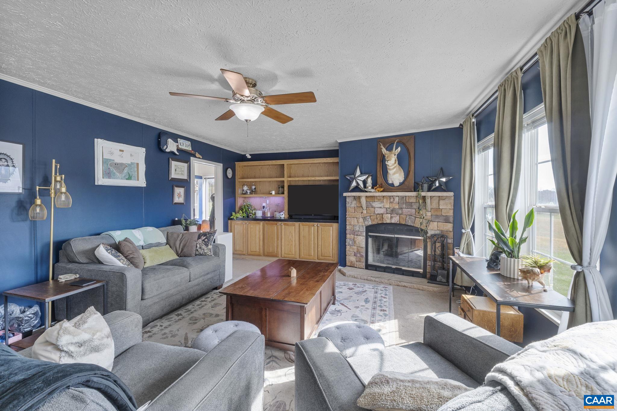 1173 Aylor Road Madison, VA 22727 - Photo 14 of 44 a living room with furniture a fireplace and a large window
