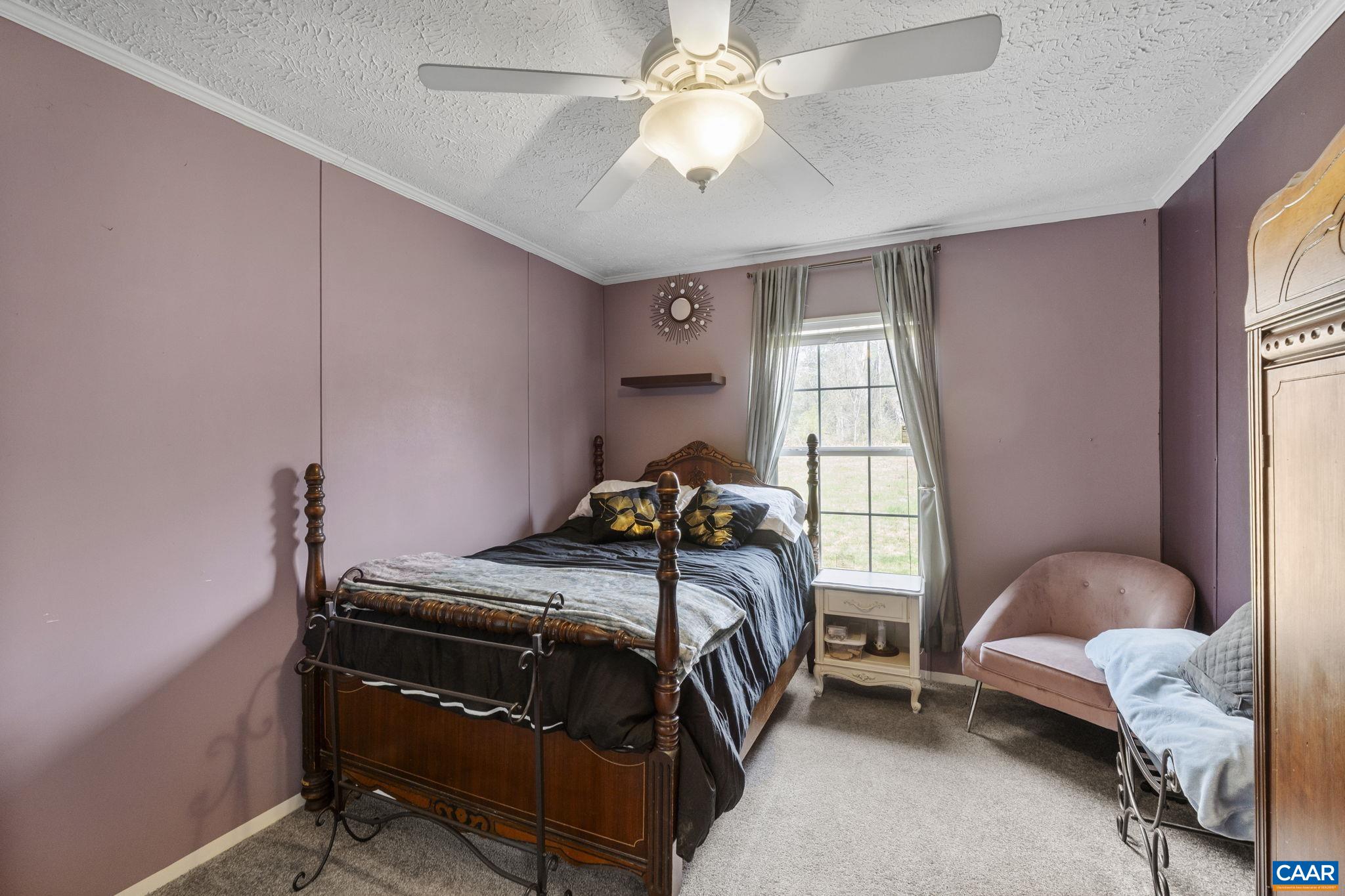 1173 Aylor Road Madison, VA 22727 - Photo 29 of 44 a bedroom with a bed and a chandelier