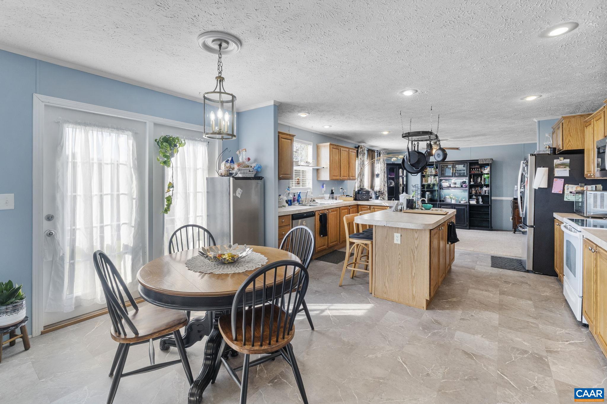 1173 Aylor Road Madison, VA 22727 - Photo 10 of 44 a dining room with furniture a chandelier and kitchen view