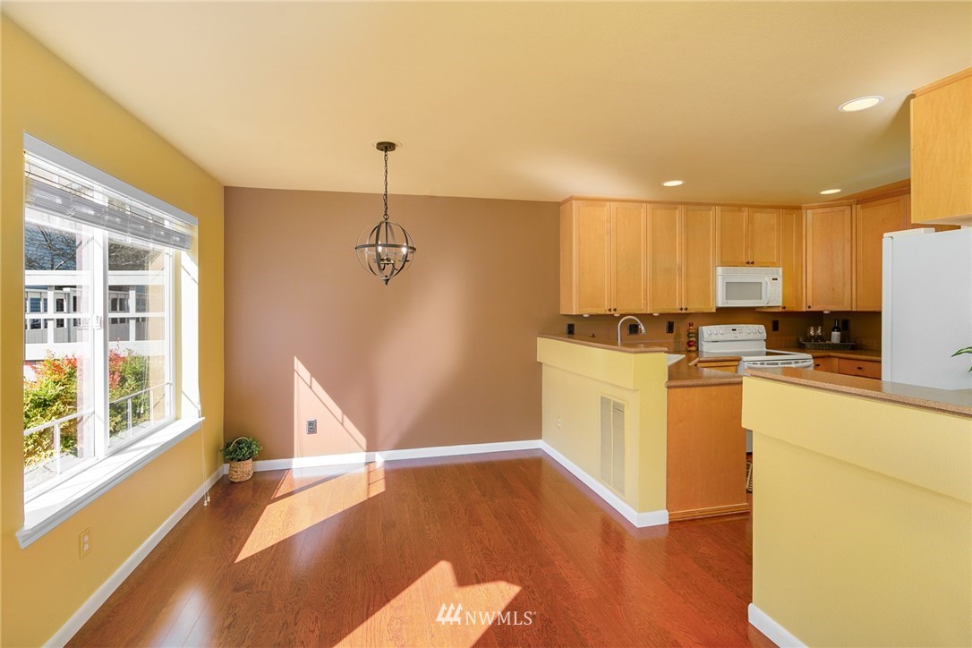 19133 110th Place Southeast Renton, WA 98055 - Photo 5 of 17 a view of a kitchen with wooden floor and electronic appliances