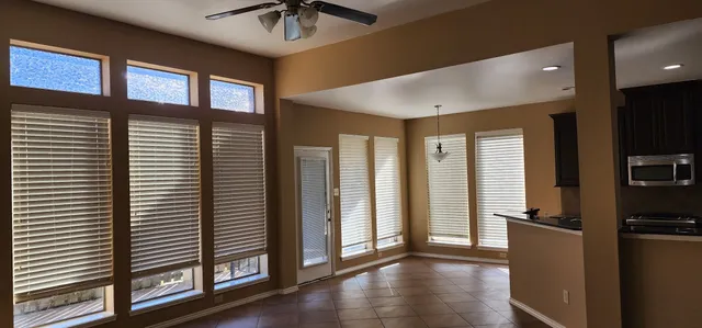 a view of a hallway with windows and chandelier