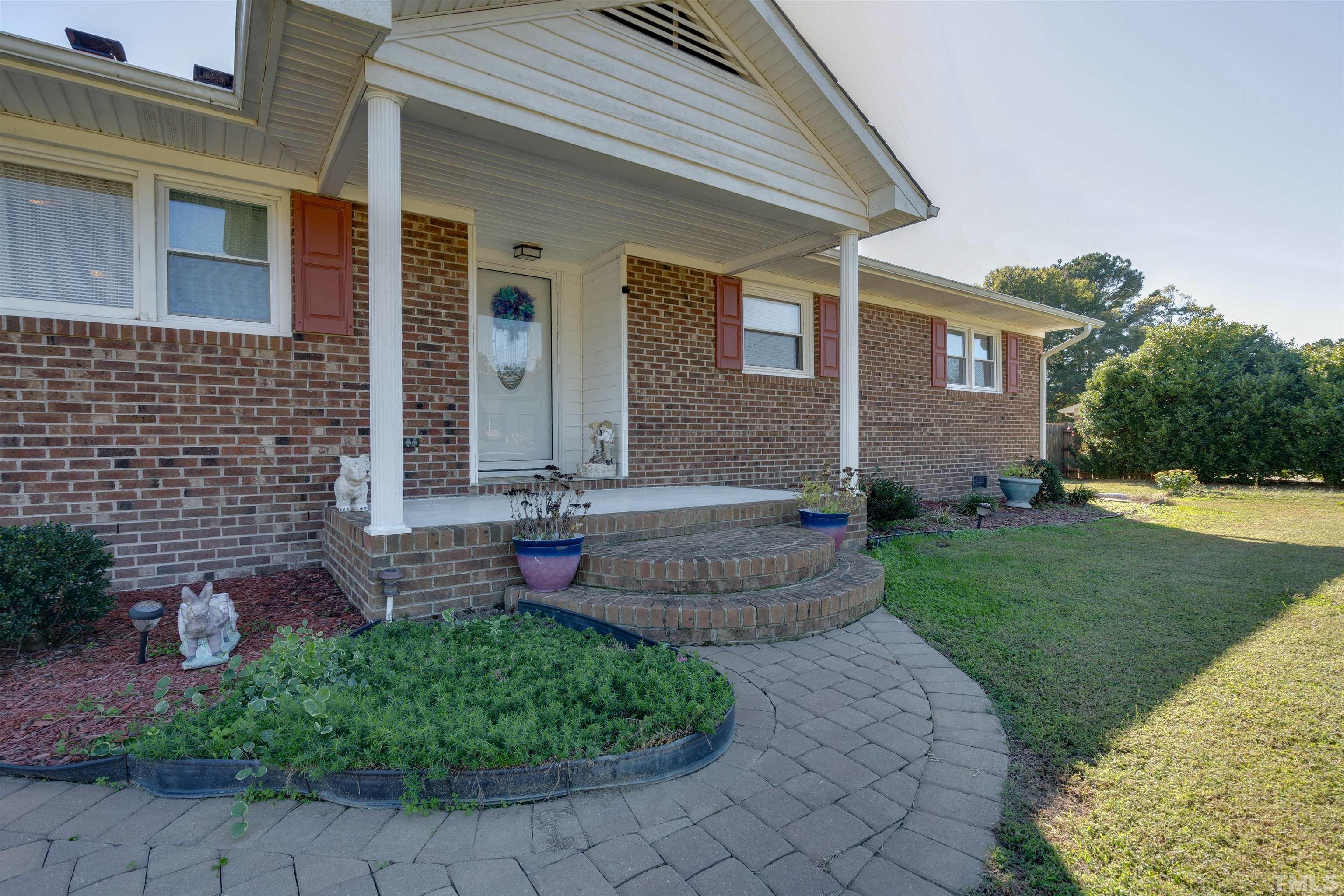 245 Pilot-Riley Road Zebulon, NC 27597 - Photo 2 of 22 a front view of a house with garden