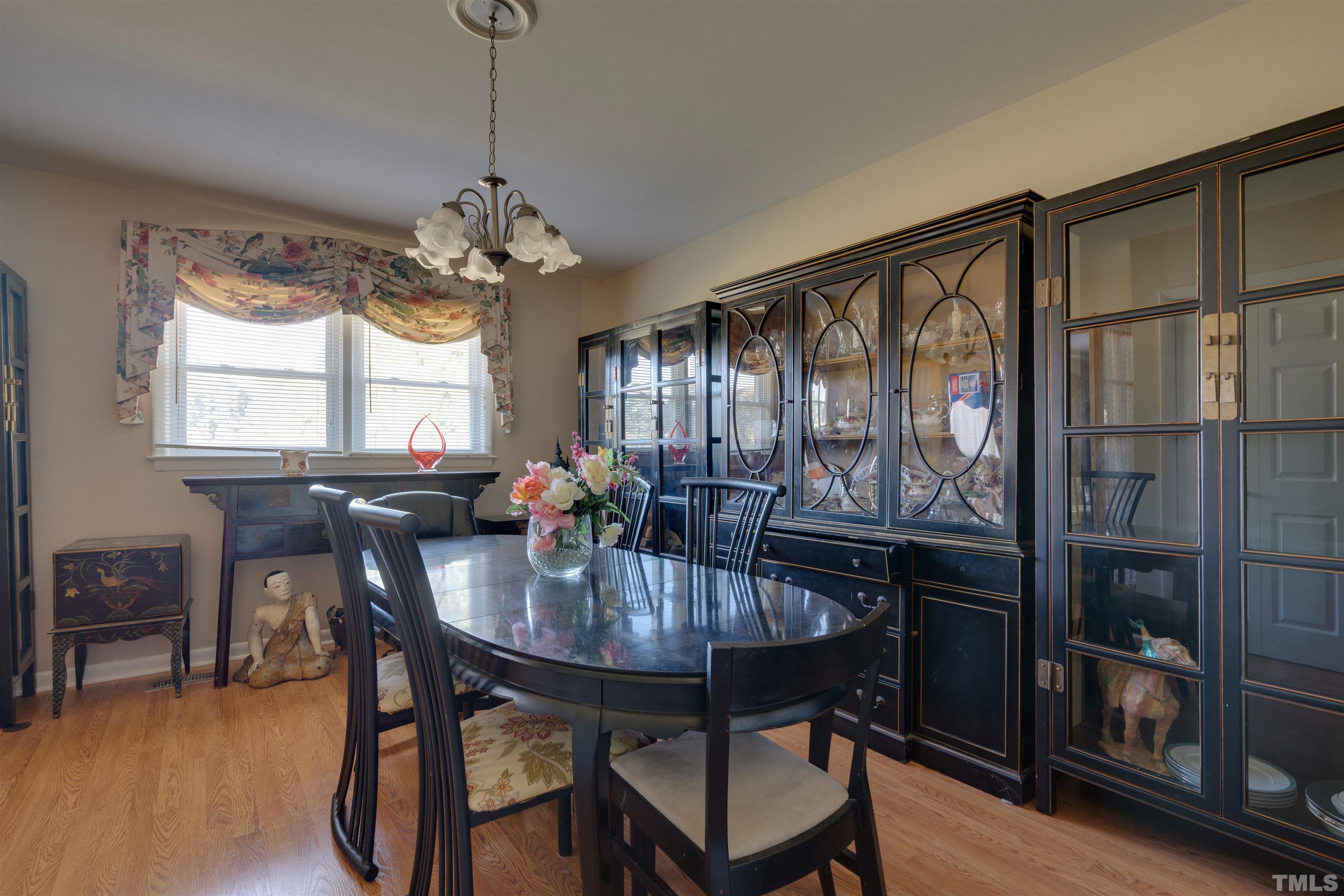 245 Pilot-Riley Road Zebulon, NC 27597 - Photo 11 of 22 a view of a dining room with furniture window and wooden floor