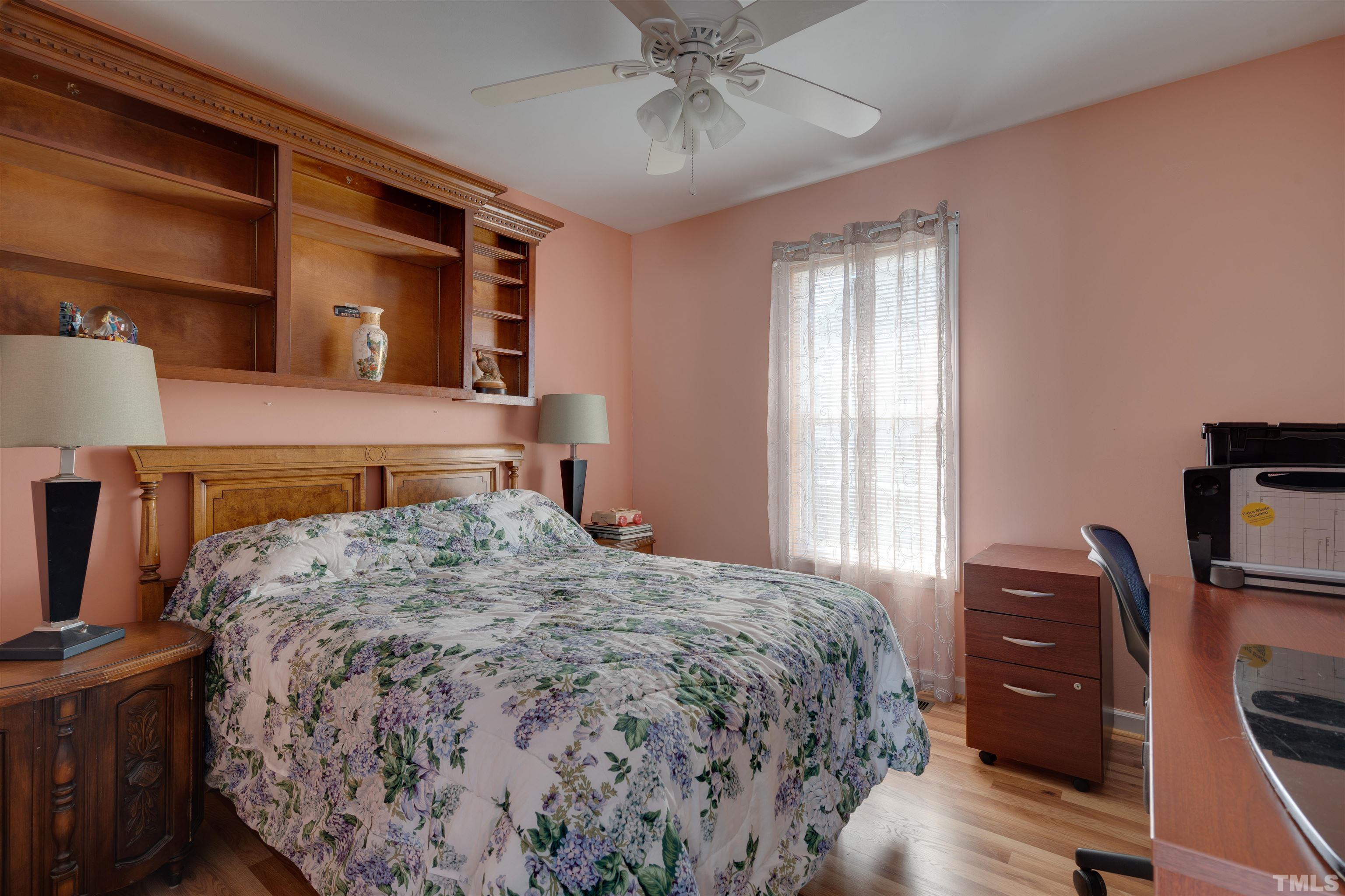 245 Pilot-Riley Road Zebulon, NC 27597 - Photo 14 of 22 a bedroom with a bed and a flat tv screen on a dresser