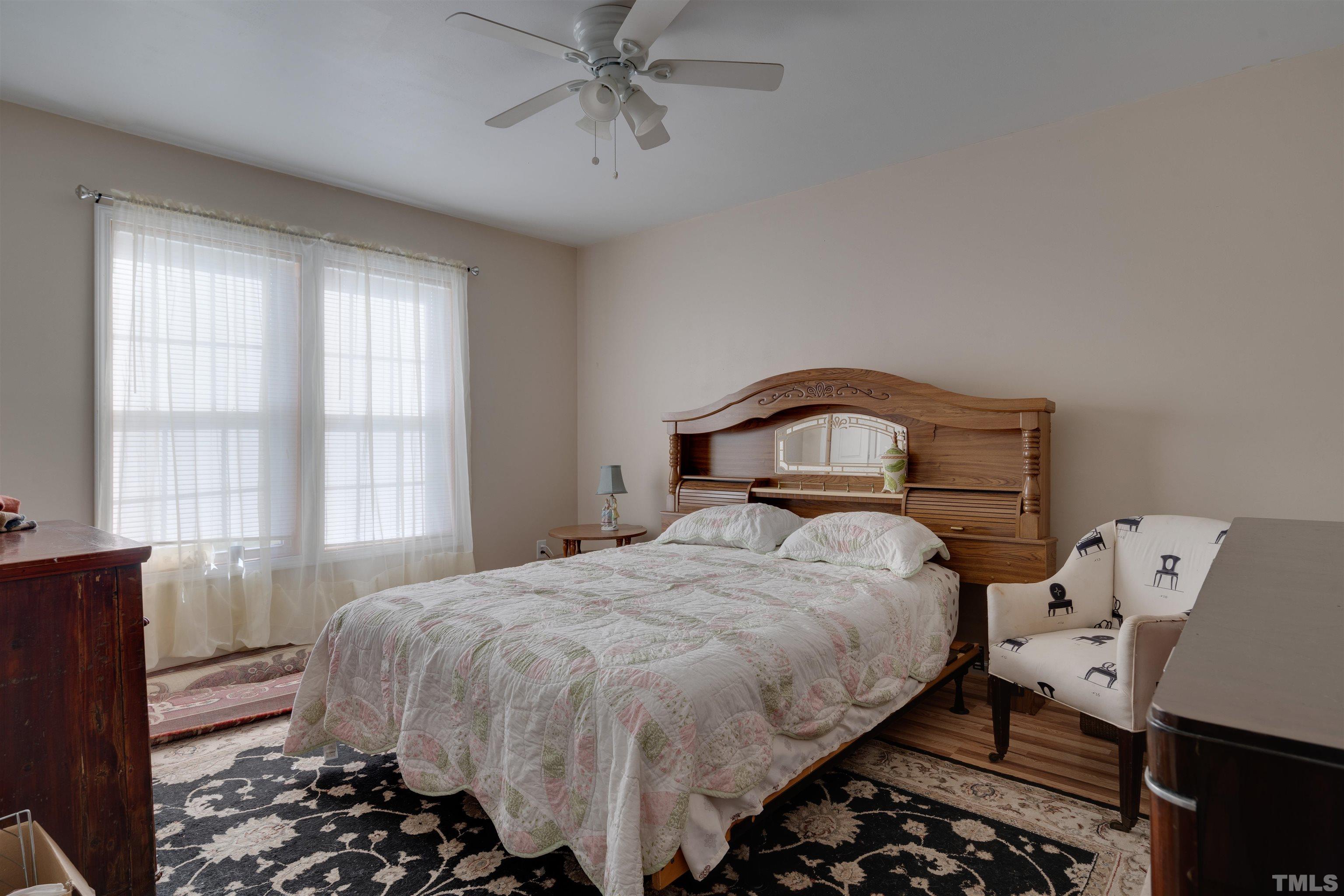 245 Pilot-Riley Road Zebulon, NC 27597 - Photo 15 of 22 a bedroom with a bed and wooden floor