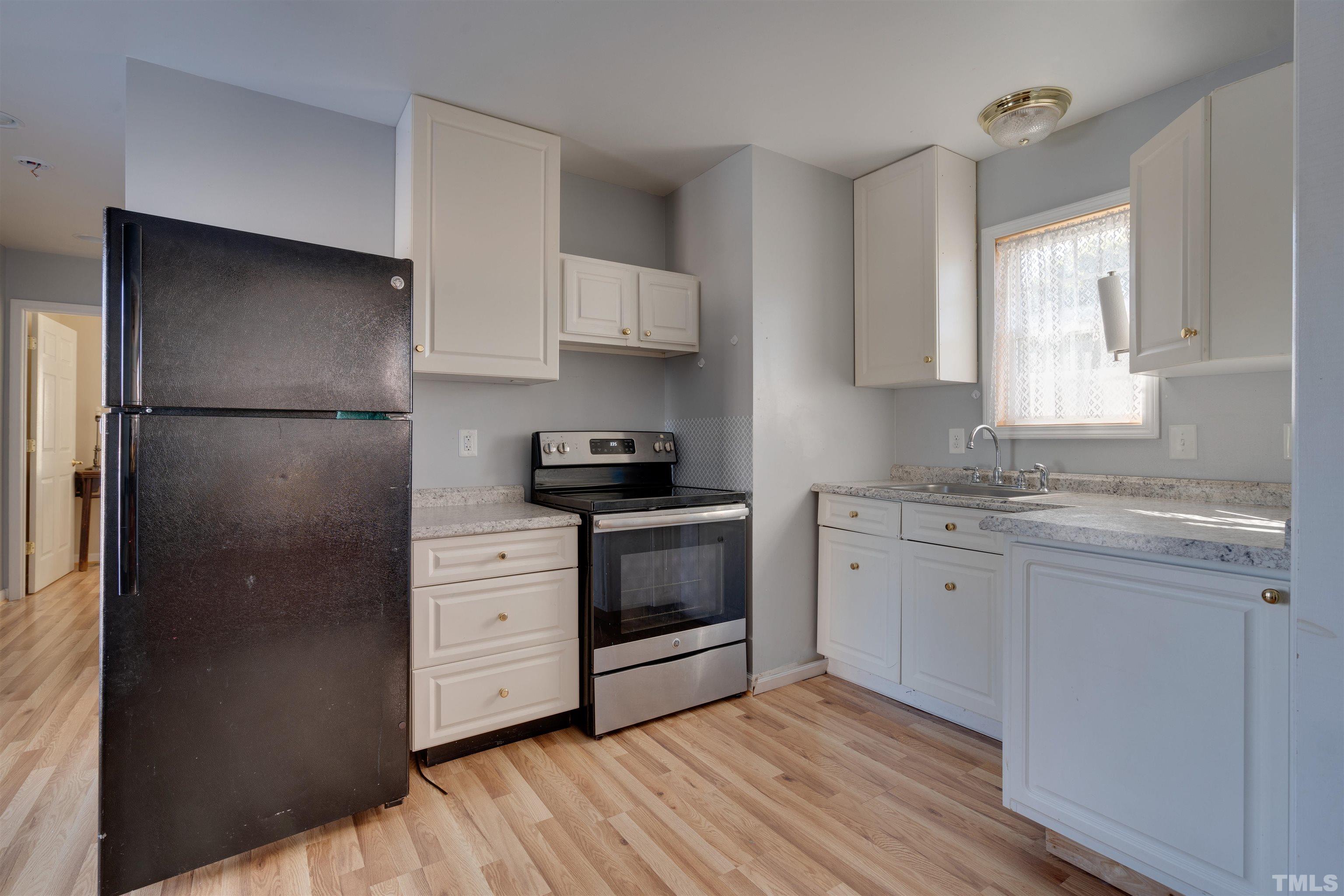 245 Pilot-Riley Road Zebulon, NC 27597 - Photo 16 of 22 a kitchen with a refrigerator stove and sink