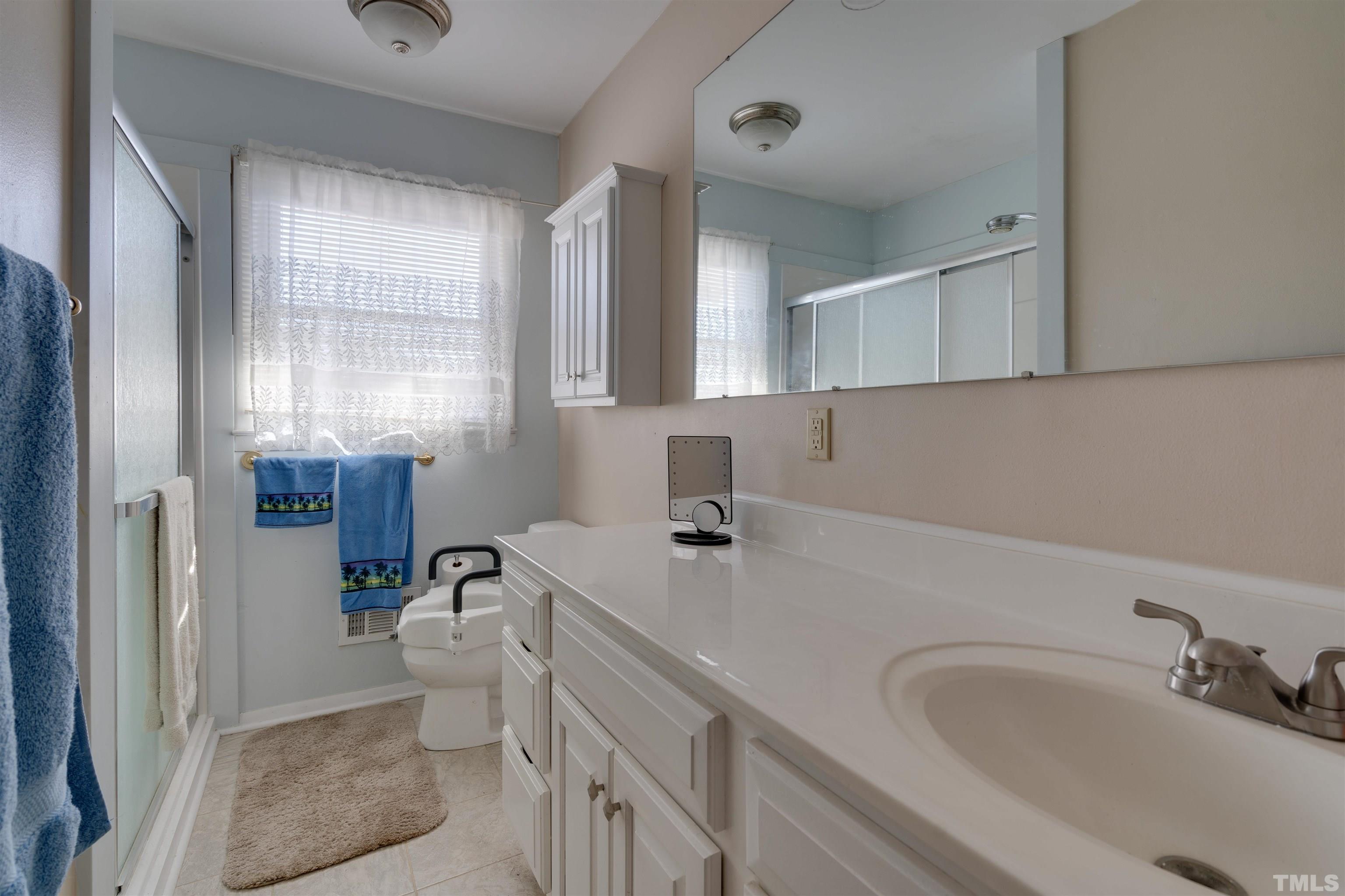 245 Pilot-Riley Road Zebulon, NC 27597 - Photo 21 of 22 a bathroom with a sink toilet and shower
