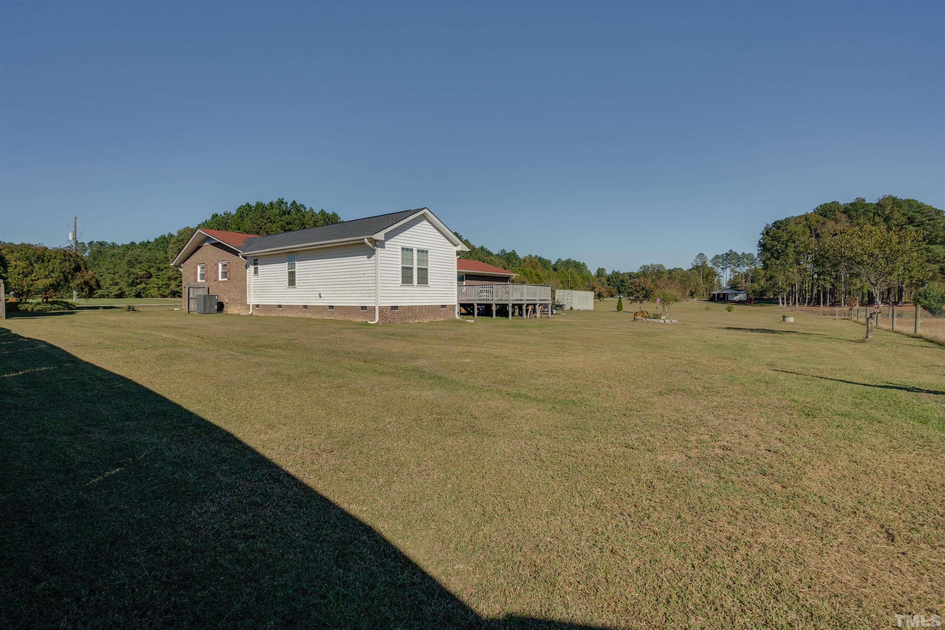 245 Pilot-Riley Road Zebulon, NC 27597 - Photo 6 of 22 a view of a house with a yard and garage