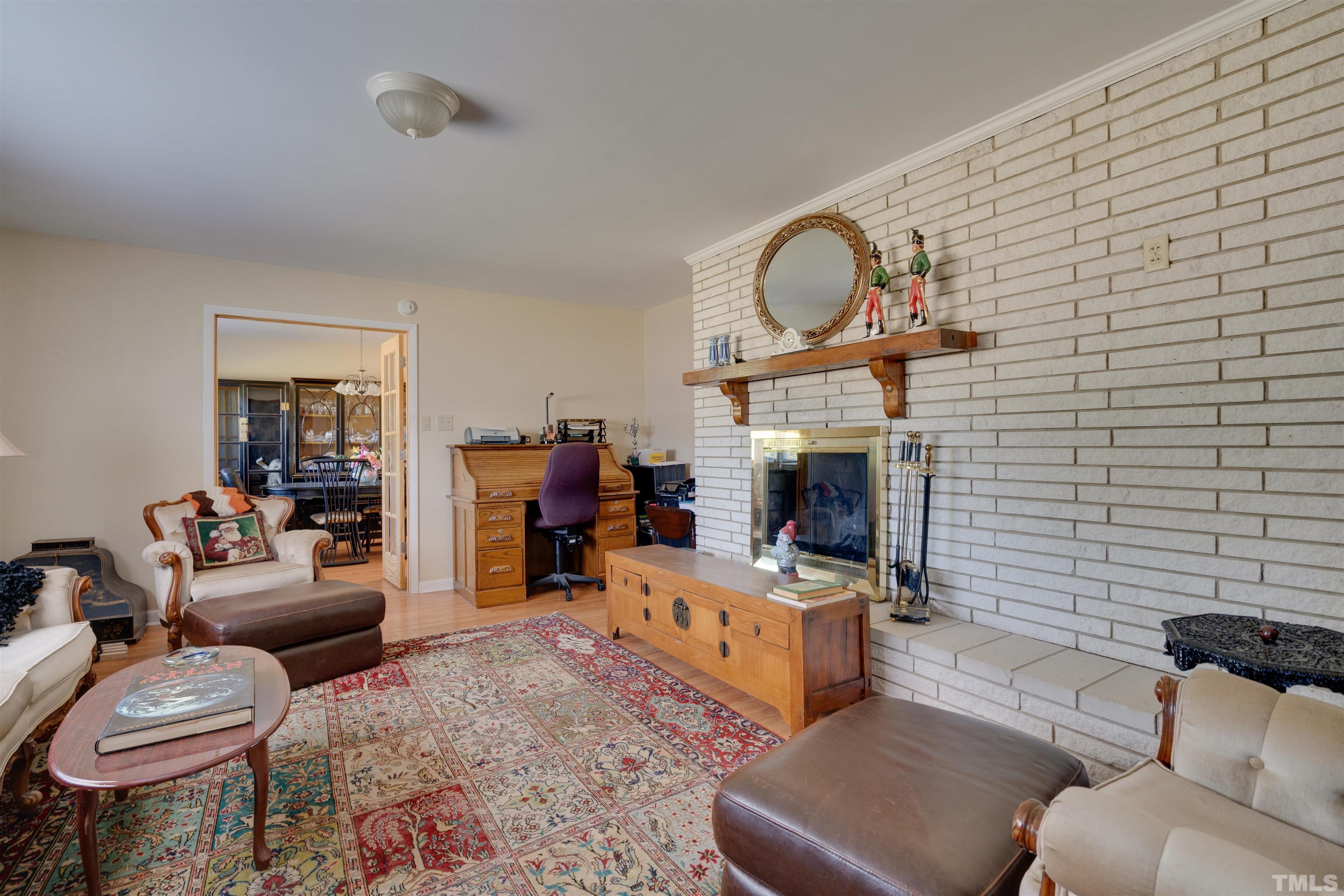 245 Pilot-Riley Road Zebulon, NC 27597 - Photo 8 of 22 a living room with furniture a fireplace and a flat screen tv