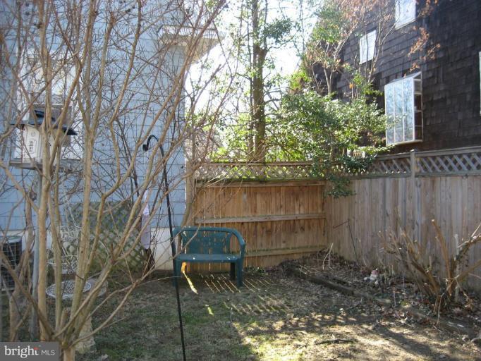 503 Westgate Road Baltimore, MD 21229 - Photo 13 of 24 a backyard of a house with lawn chairs and wooden fence