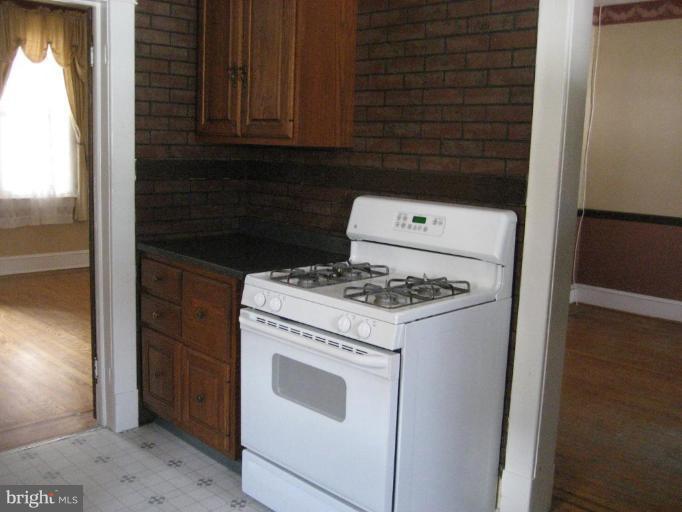 503 Westgate Road Baltimore, MD 21229 - Photo 24 of 24 a stove top oven sitting inside of a kitchen