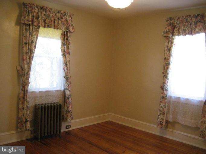 503 Westgate Road Baltimore, MD 21229 - Photo 4 of 24 a view of a small space with wooden floor and a window