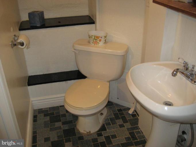 503 Westgate Road Baltimore, MD 21229 - Photo 6 of 24 a bathroom with a sink and a toilet