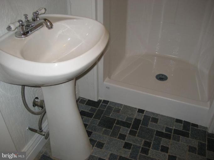 503 Westgate Road Baltimore, MD 21229 - Photo 7 of 24 a bathroom with a shower and a sink