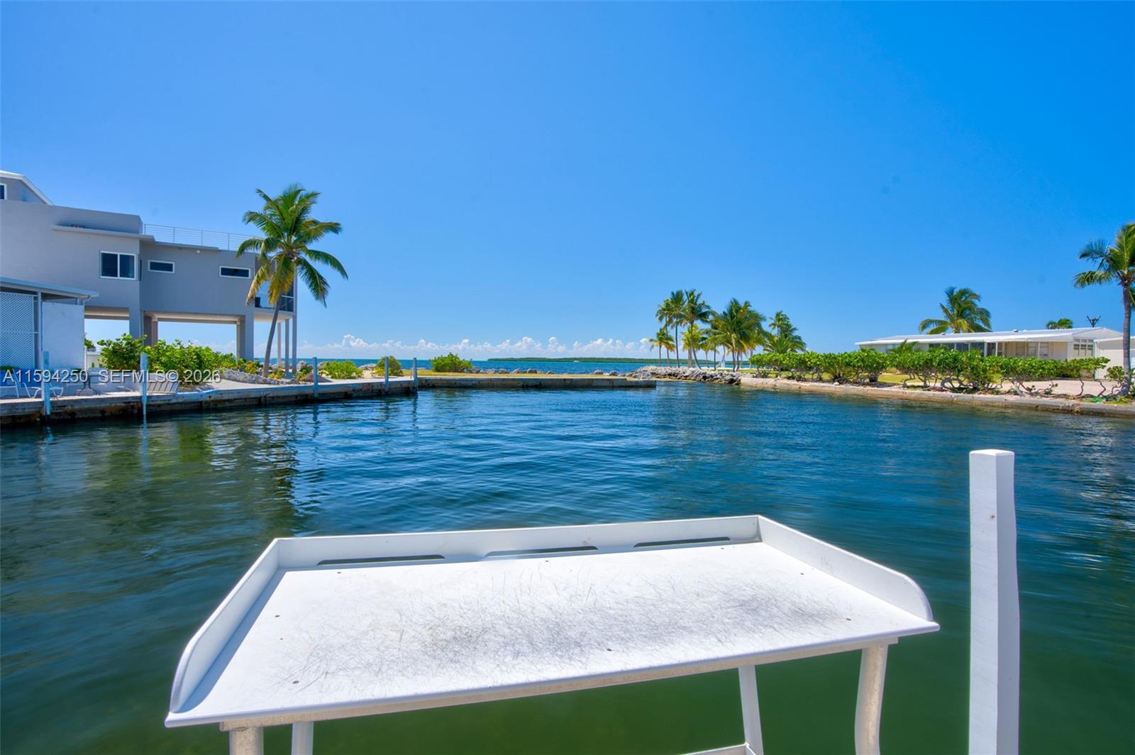 84 Coral Way Key Largo, FL 33037 - Photo 53 of 55 a view of a lake with a house in the background