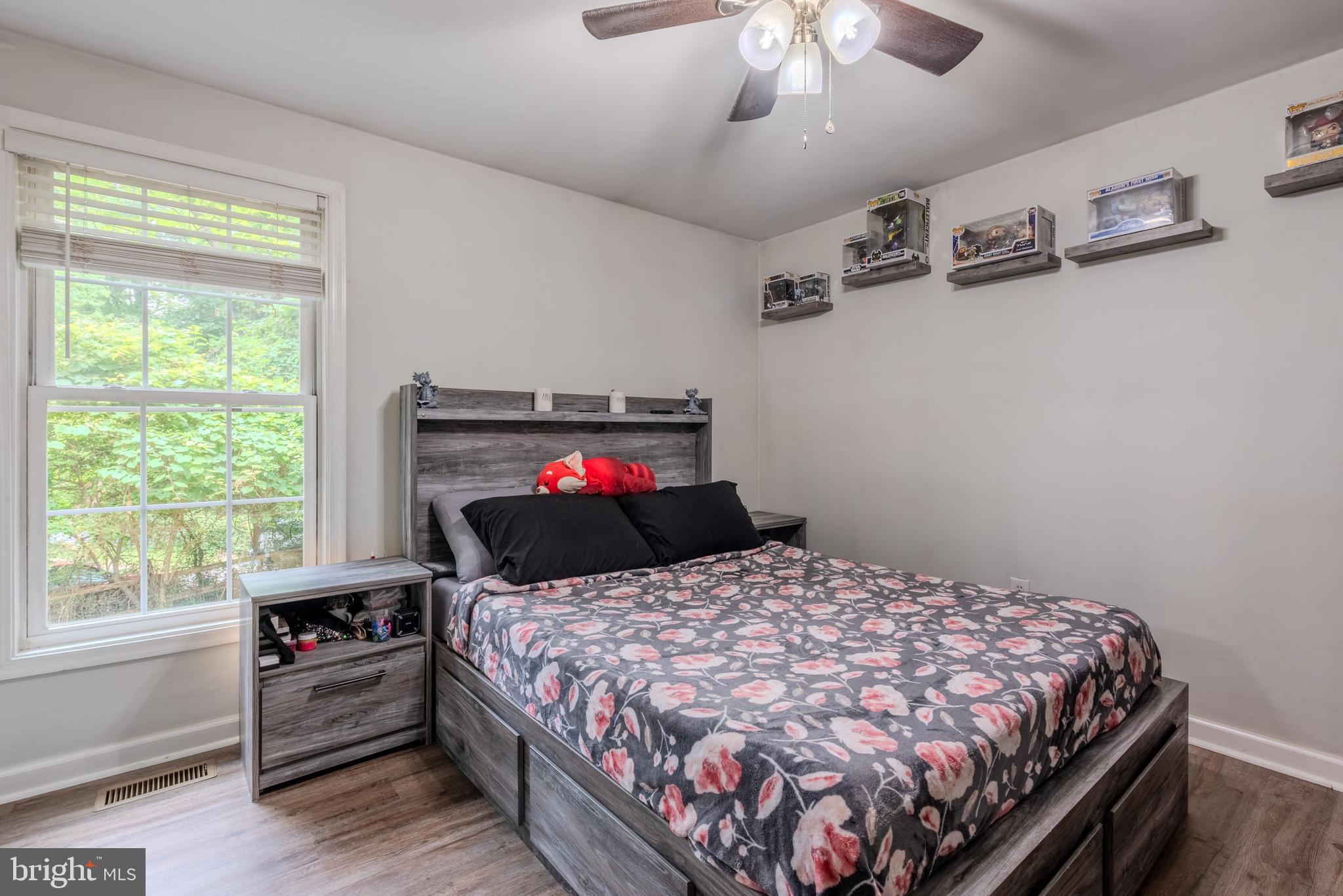 668 Running Fox Road Lusby, MD 20657 - Photo 8 of 12 a bedroom with a bed and wooden floor