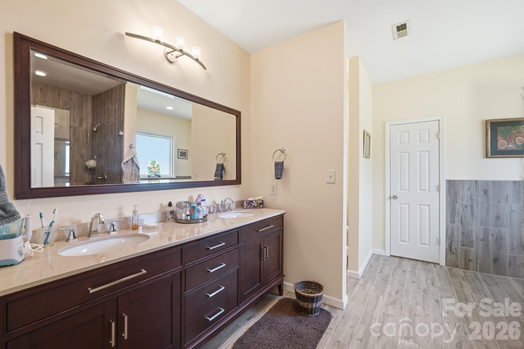 4415 Old Monroe Marshville Road Wingate, NC 28174 - Photo 12 of 28 a bathroom with a double vanity sink and a mirror
