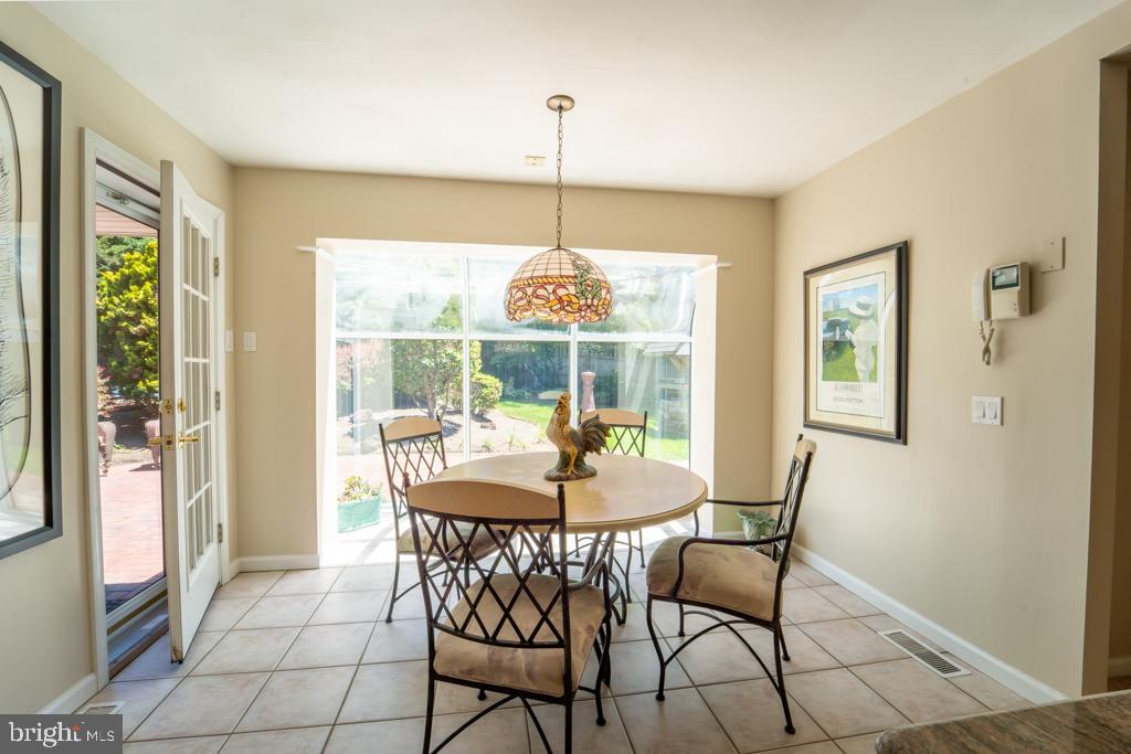 1409 Hampton Road Rydal, PA 19046 - Photo 14 of 50 a dining room with furniture a chandelier and wooden floor