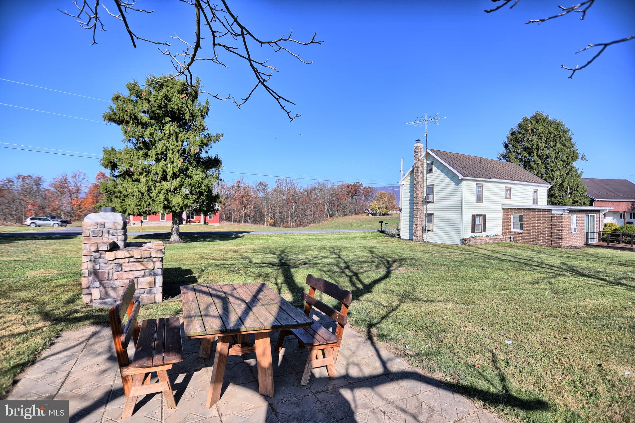231 Mohawk Road Newville, PA 17241 - Photo 41 of 72 a view of a patio with table and chairs potted plants with wooden floor and fence