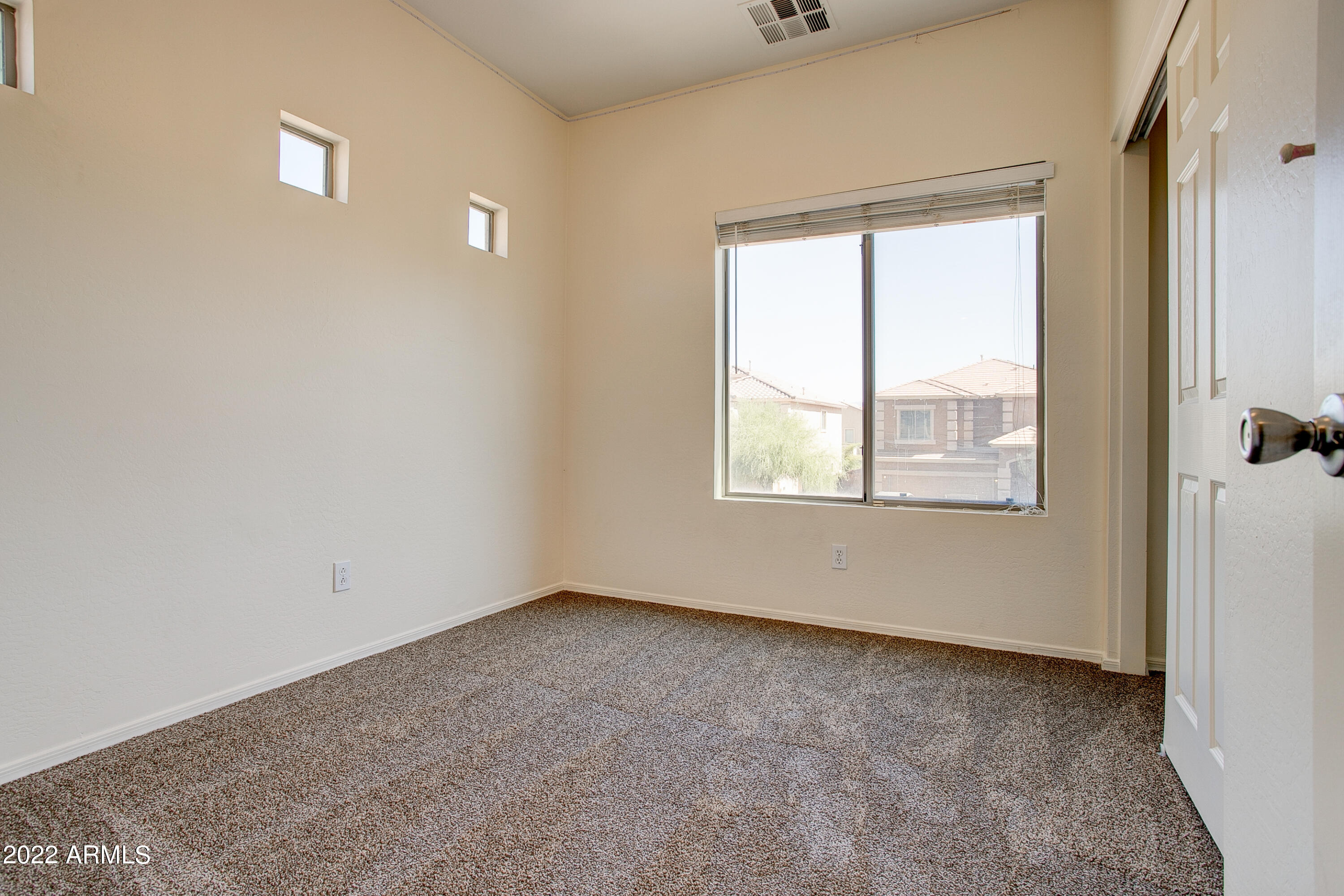 9928 West Chipman Road Tolleson, AZ 85353 - Photo 18 of 42 an empty room with a window